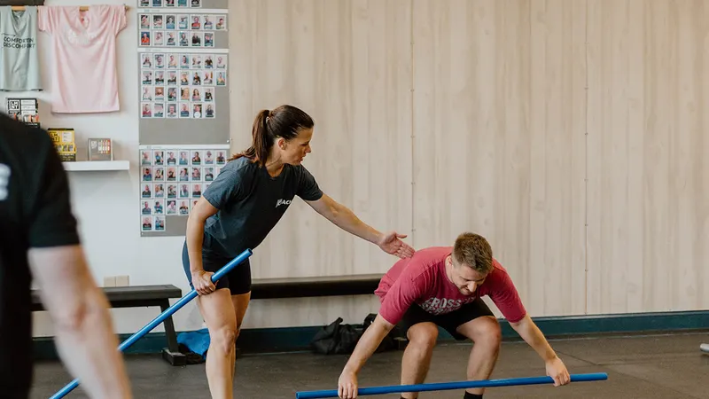 Coach guiding members through movement prep in an adult CrossFit class at CrossFit Spring Hill